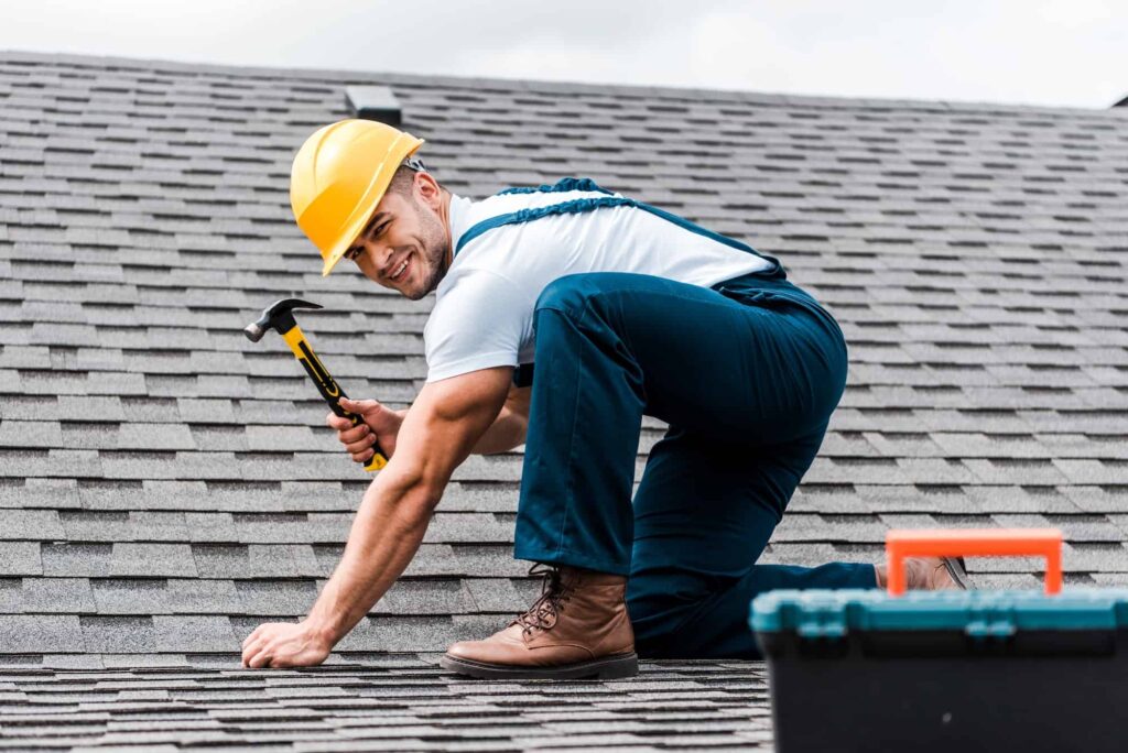 Handyman repairing roof for roof certificate
